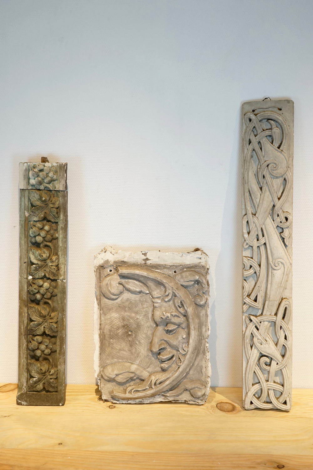 Two ornamental plaster casts and one moon plaque, 19/20th C., Bruges