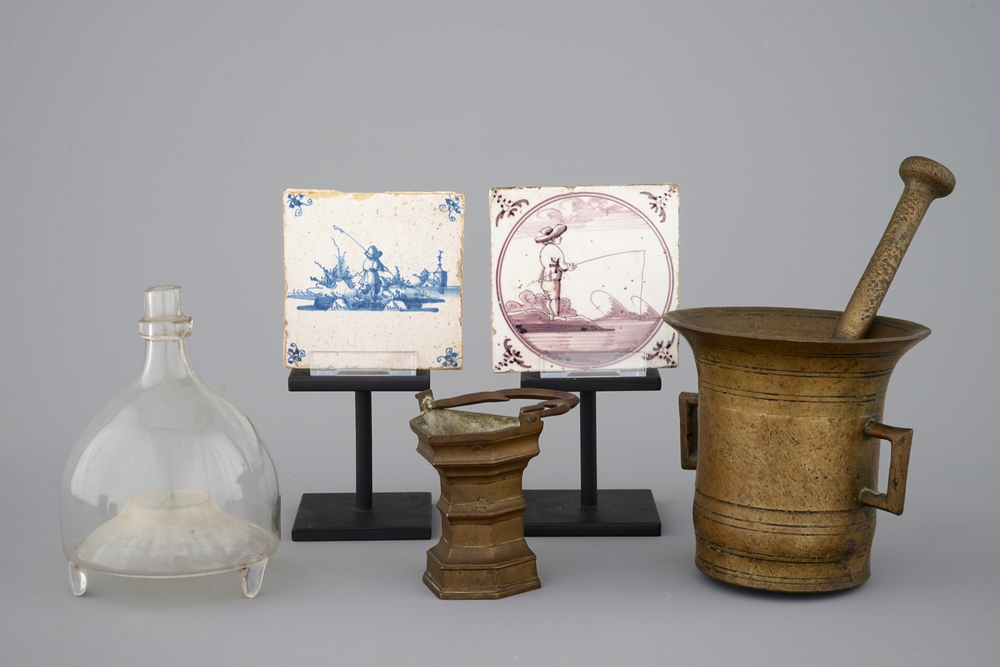 A varied lot of 2 Delft tiles, a mortar and pestle, a holy water pail and a hand blown glass wasp trap, 18/19th C.