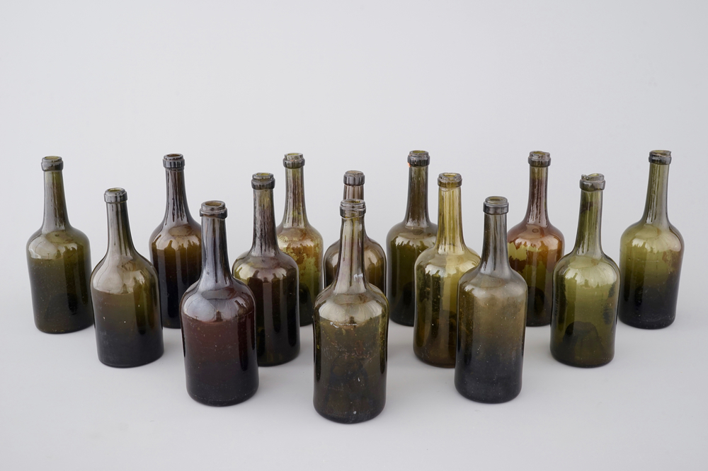 A set of 14 empty hand-blown green glass wine bottles, 18/19th C.