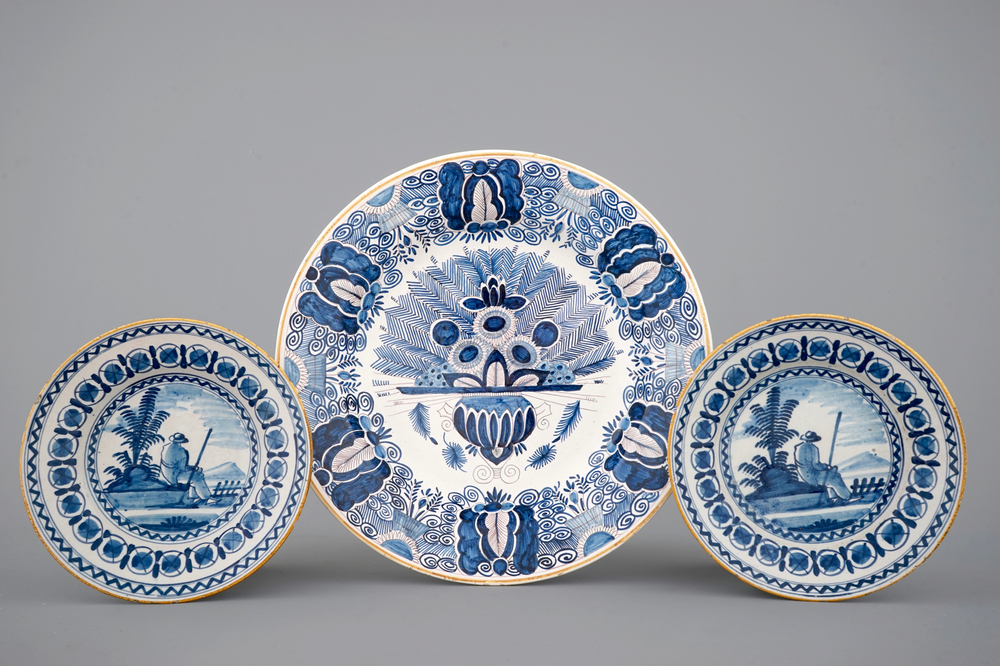 A pair of blue and white Dutch Delft pastoral plates and a peacock's tail dish, 18/19th C.