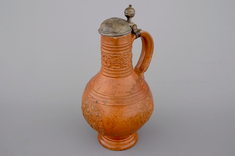 A tall Raeren stoneware jug with the Roman god Mercury, dated 1618