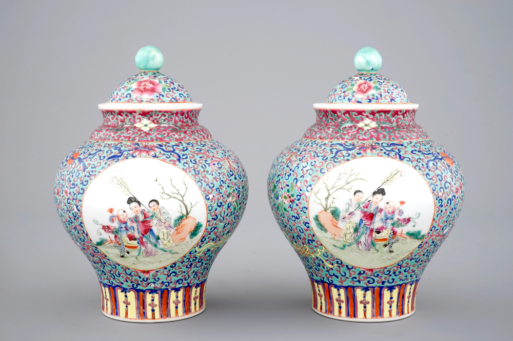 A pair of Chinese porcelain famille rose jars and covers, 20th C.