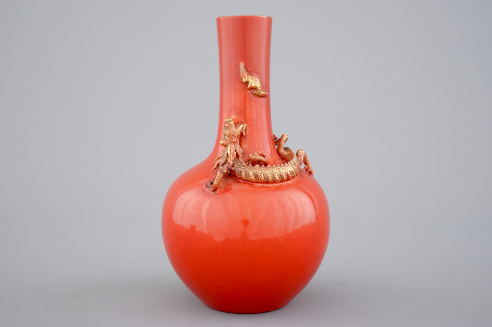 A Chinese porcelain coral red ground dragon vase, 19th C.