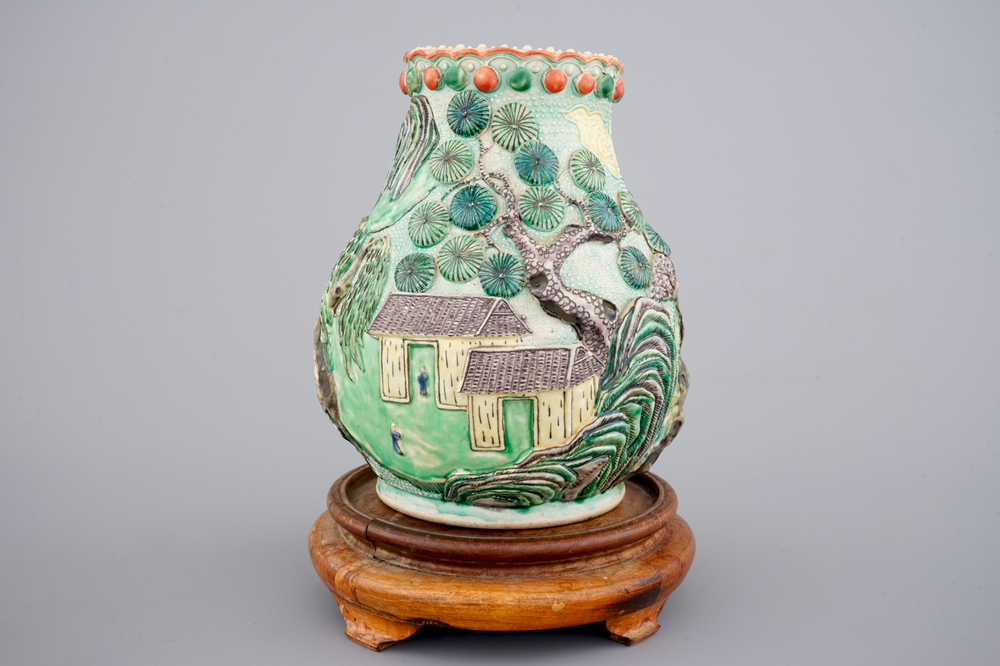 A Nanking famille verte relief-decorated hu-shaped landscape vase, 19th C.