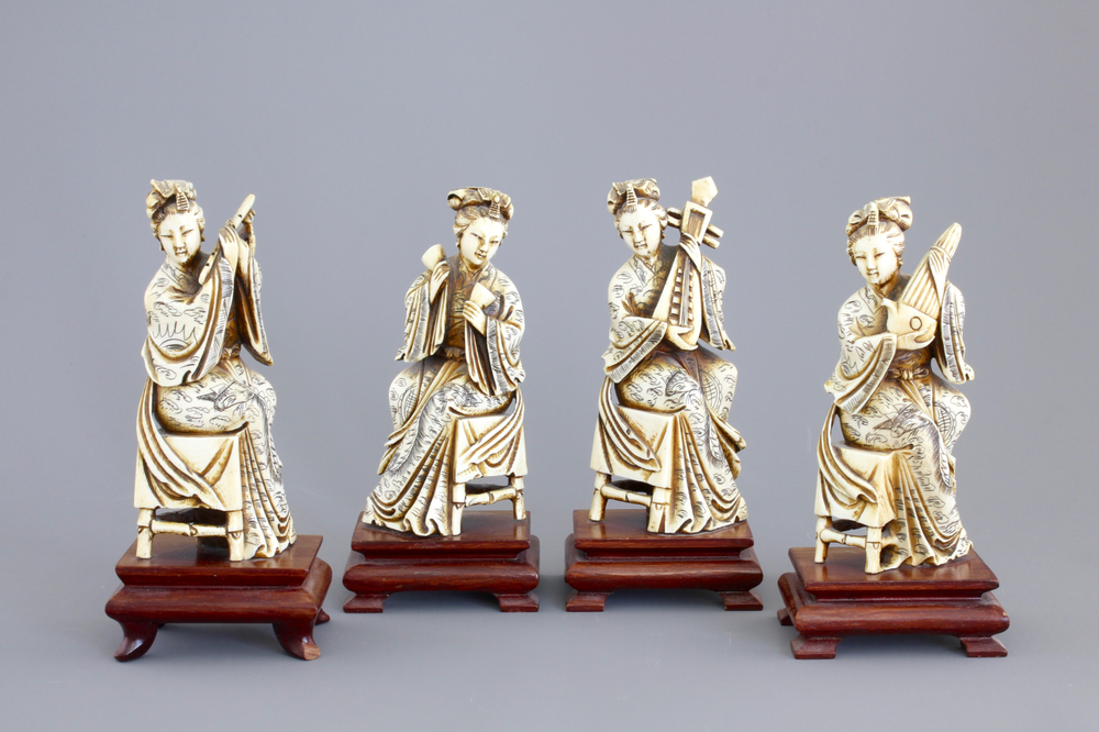 Four Chinese carved ivory ladies with instruments on wooden stands, ca. 1900