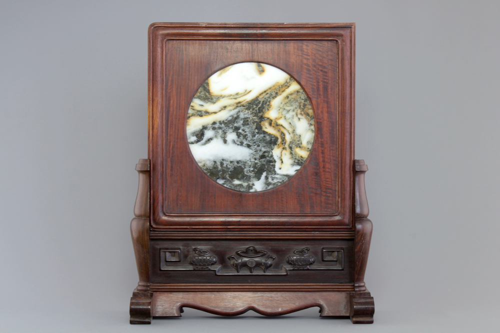 A Chinese dream stone plaque in a carved hardwood stand, 19/20th C.