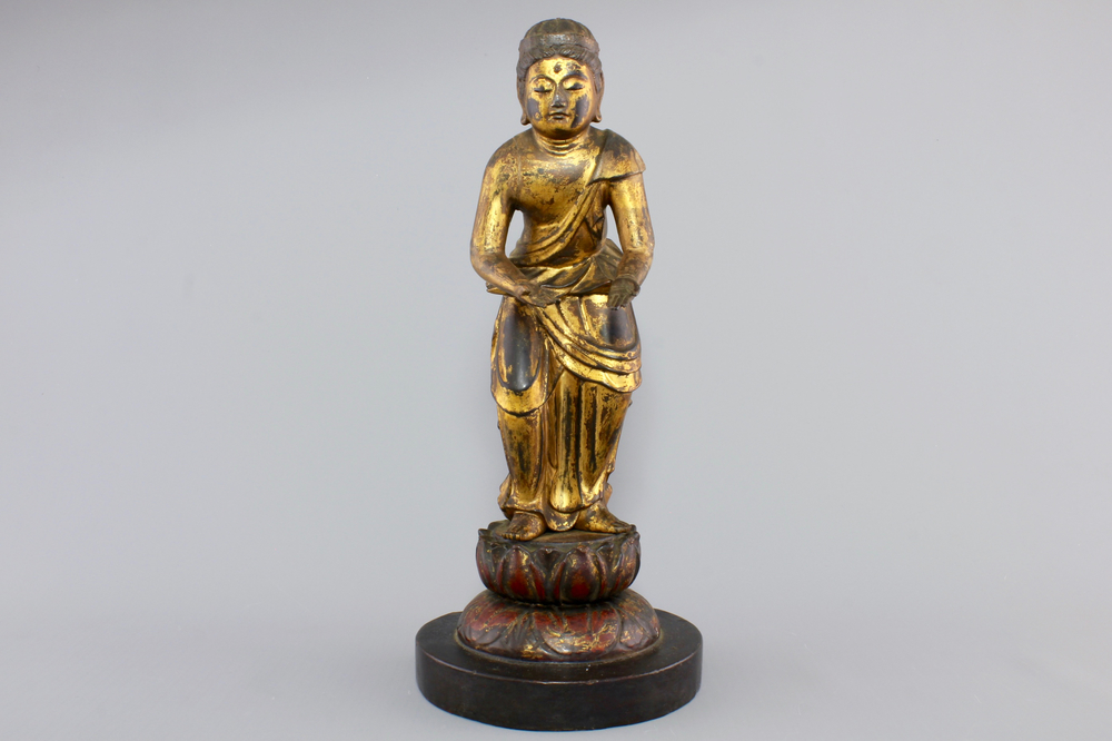 A Chinese gilt and laquered wood figure of a female deity, 18/19th C.