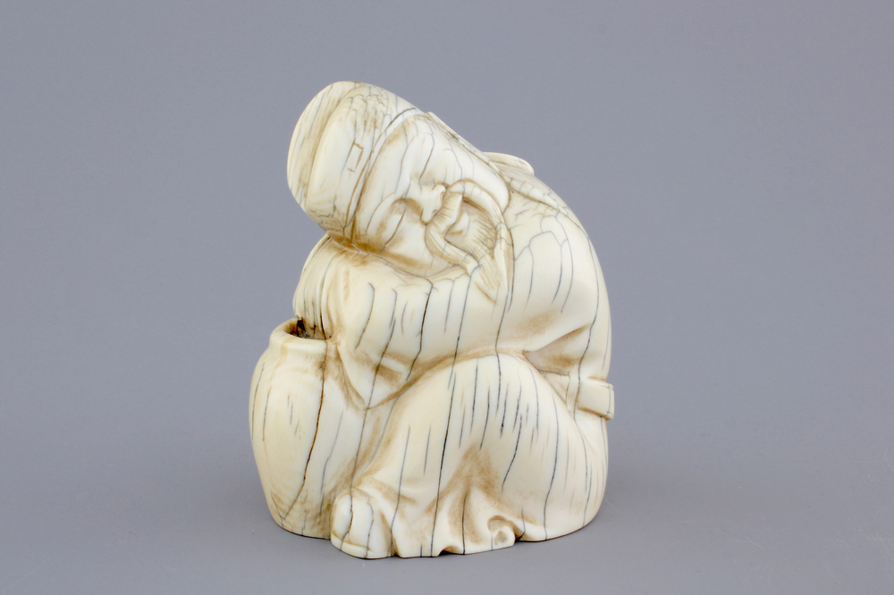 A Chinese carved ivory figure of a sage, signed, 19th C.