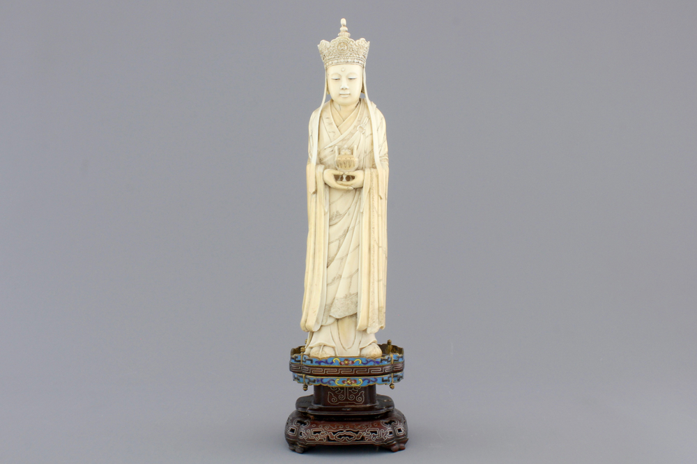 A fine Chinese carved ivory deity with an incense burner on a cloisonne and silver inlaid stand, 19th C.