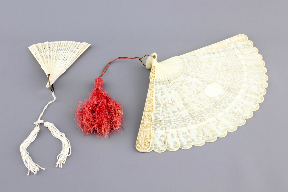 Two Chinese Canton carved and pierced ivory fans, 19th C.