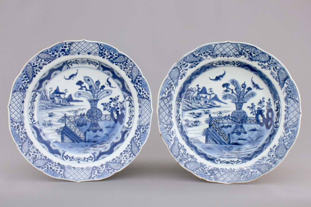 A pair of blue and white Chinese porcelain plates with a vase in a garden, Qianlong, 18th C.