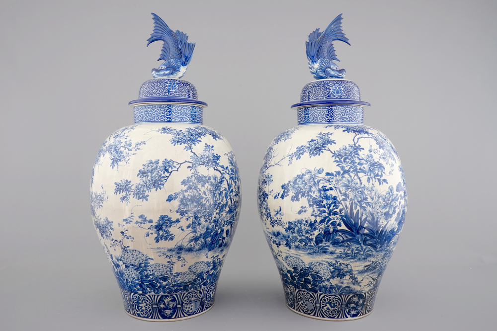 A tall pair of Japanese Arita porcelain blue and white vases and covers, ca. 1860