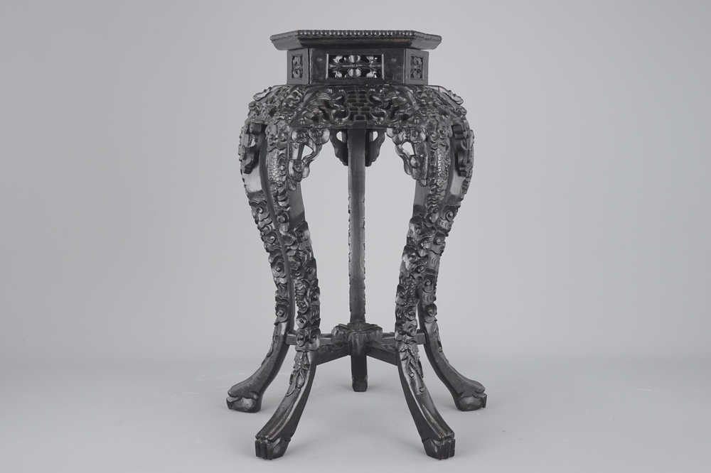 An intricately carved Chinese hardwood marble top vase stand, 19th C.