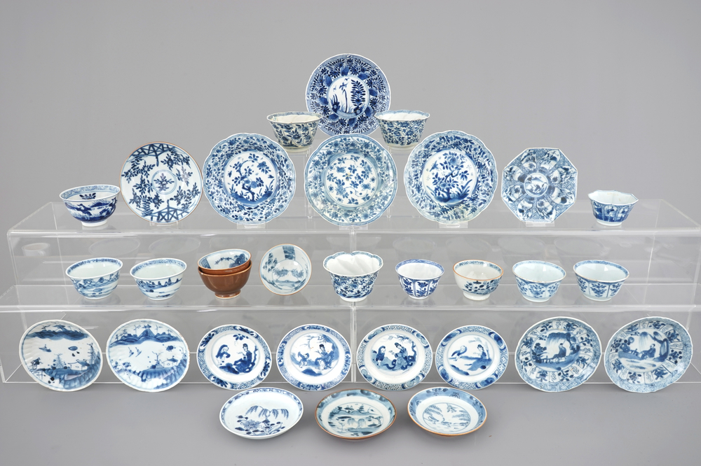 A large collection of Chinese blue and white cups and saucers, mostly Kangxi, 18th C.