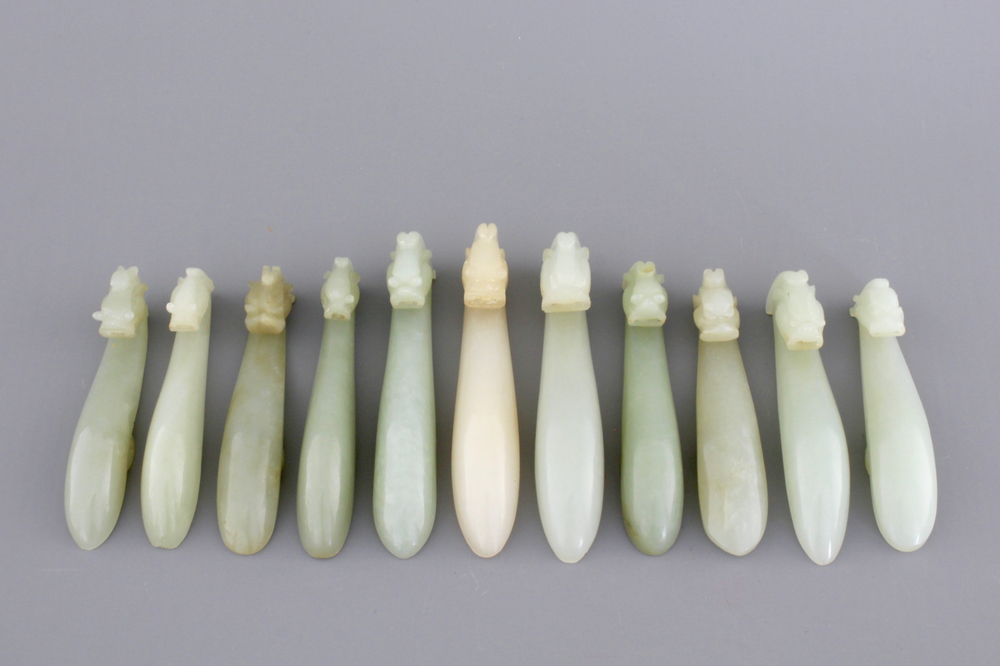 An interesting collection of 11 white and pale celadon jade belt hooks, 19th C.