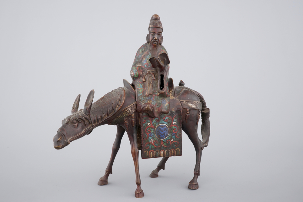 A Japanese champlev&eacute; enamel and bronze figure of a sage riding a donkey, 19th C.