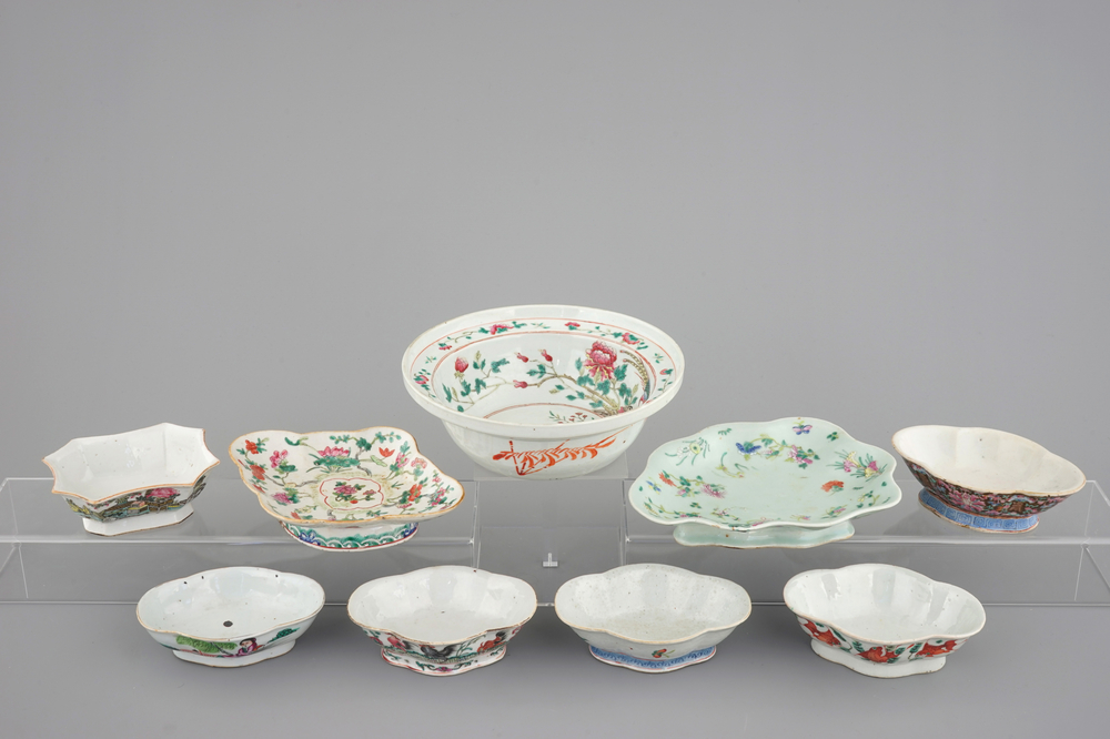 A Chinese famille rose basin with a bird on a branch and 8 smaller bowls, 19th C.