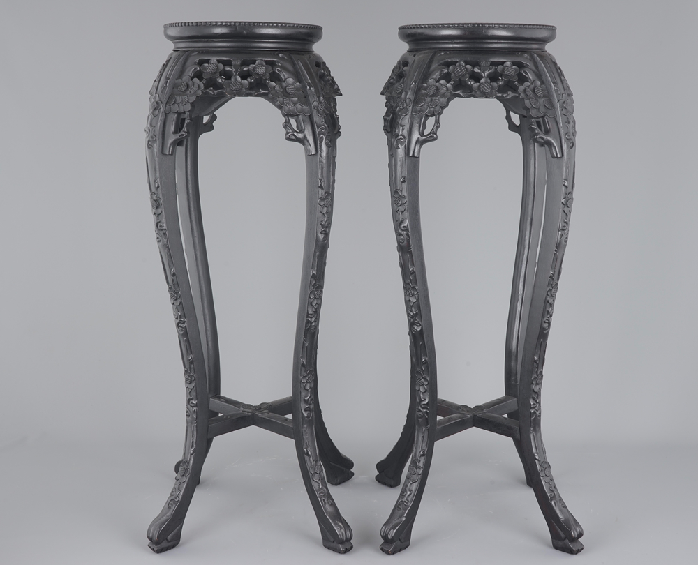 A tall pair of Chinese carved stands with marble top, 19th C.