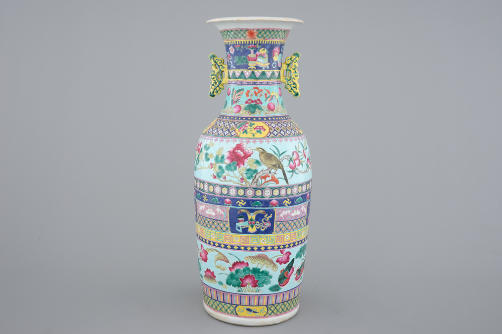 A tall Chinese famille rose vase with birds among flowers between colored bands of symbolim, 19th C.
