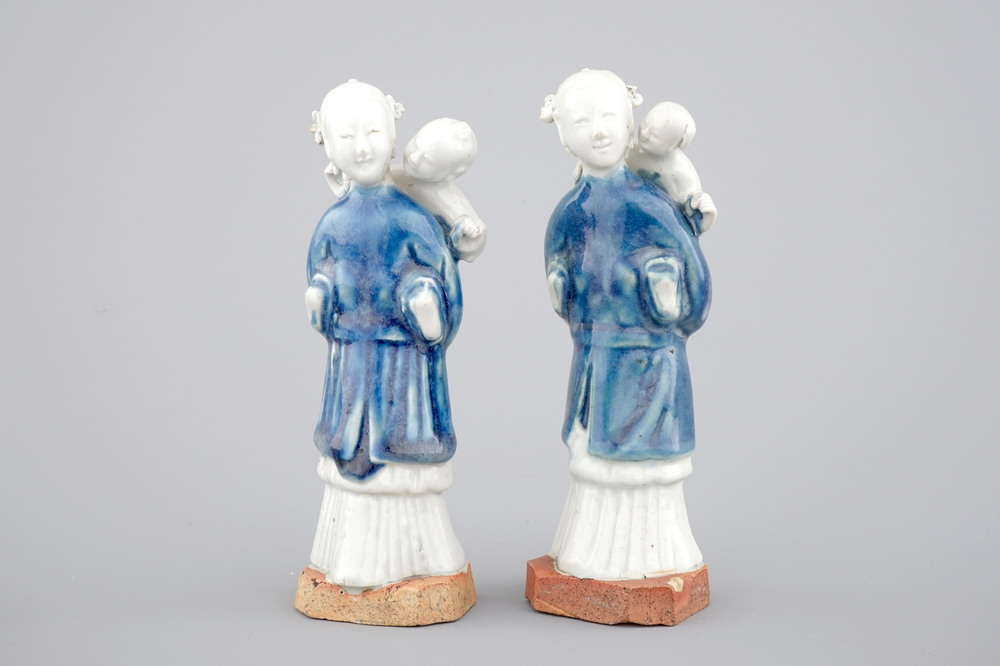 Two Chinese blue and white figures of a lady with child on biscuit base, Qianlong, 18th C.