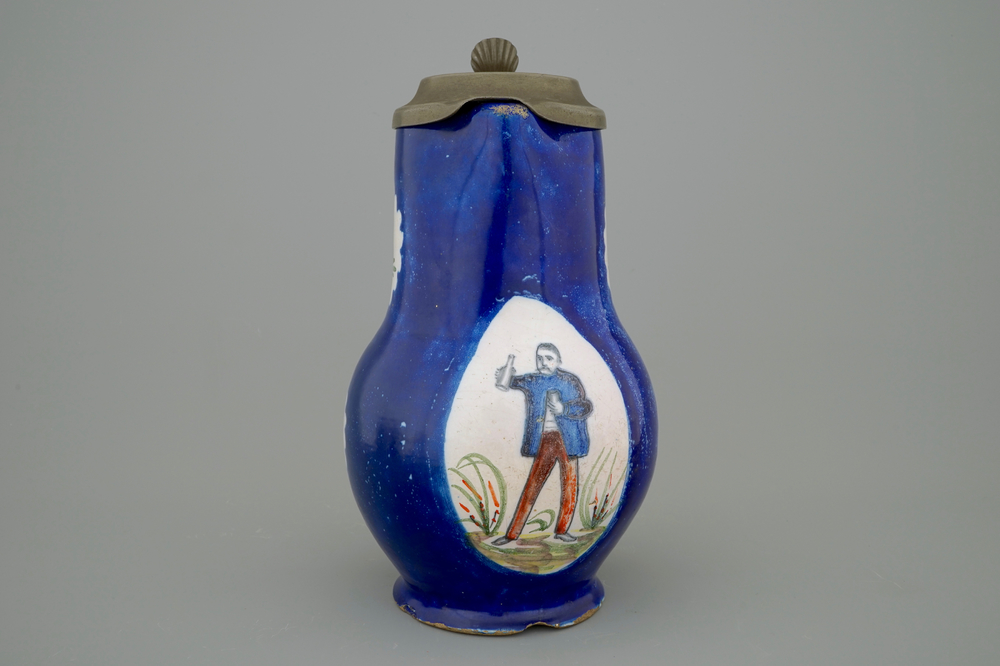 A Brussels faience jug with a drinking man, late 18th C.