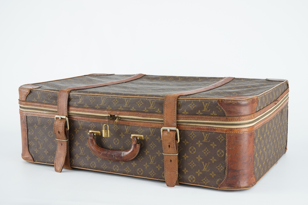 A Louis Vuitton leather travel suitcase, mid 20th C.