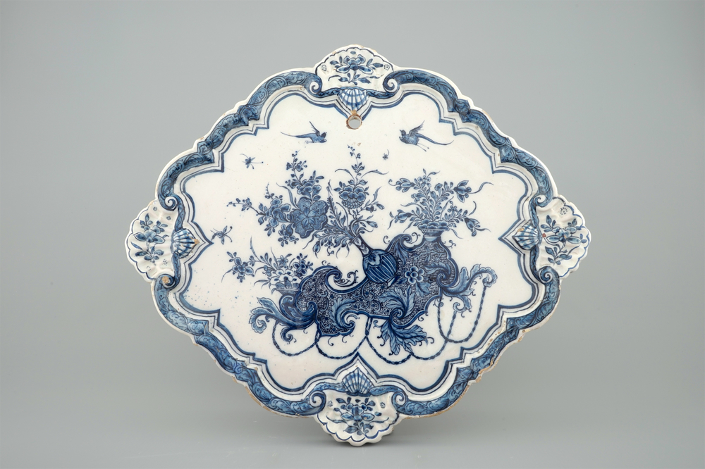A Dutch Delft blue and white plaque with flower vases, 18th C.