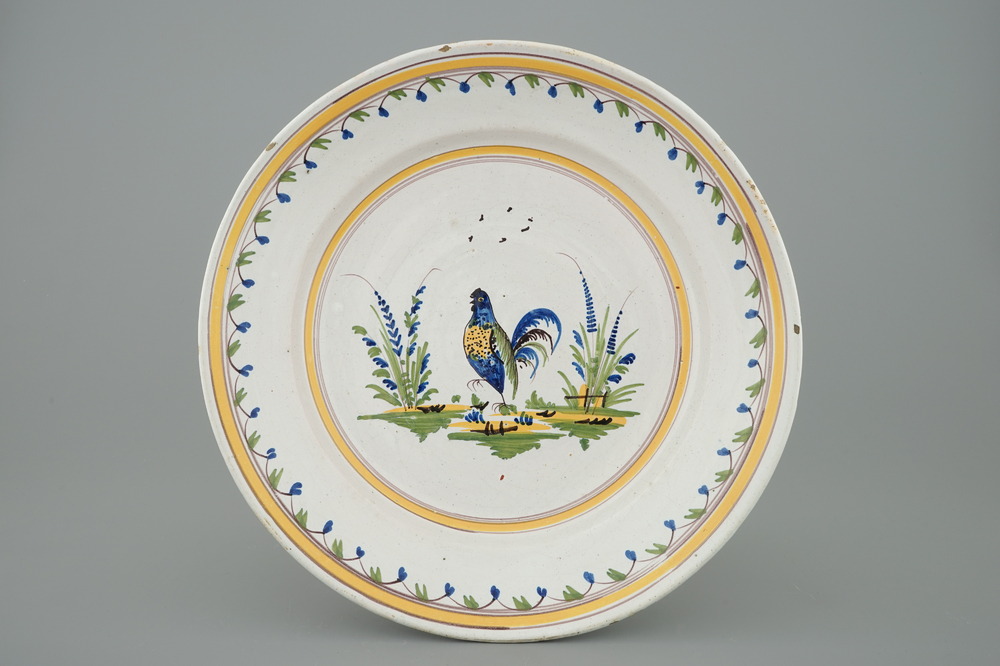 A polychrome Brussels faience plate with a cockerel, 18th C.