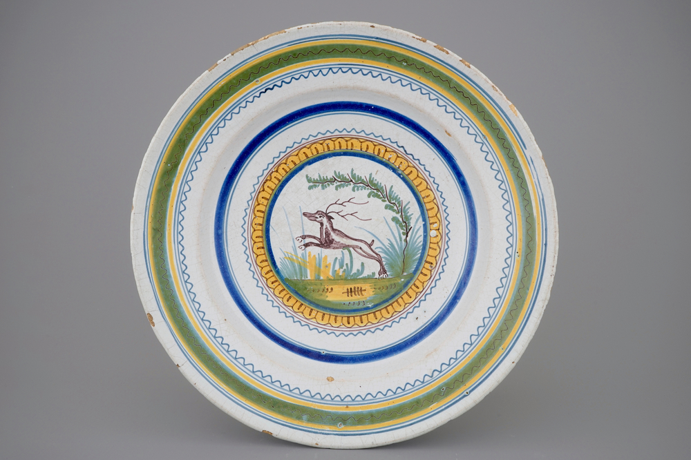 A polychrome Brussels faience dish with a deer, 18th C.