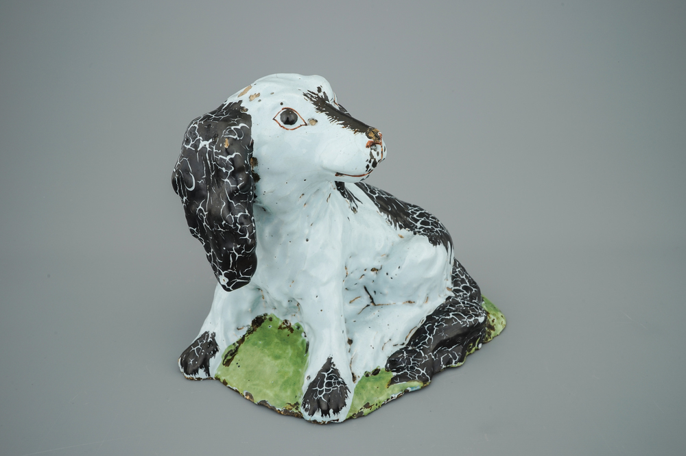 A polychrome Brussels faience model of a dog, 18th C.