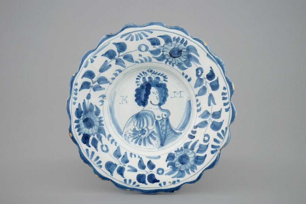A Dutch Delft lobed plate with the portrait of Queen Mary, late 17th C.