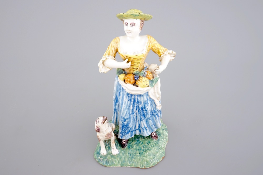 A tall polychrome pottery group of a lady with a dog, Nevers, 18th C.