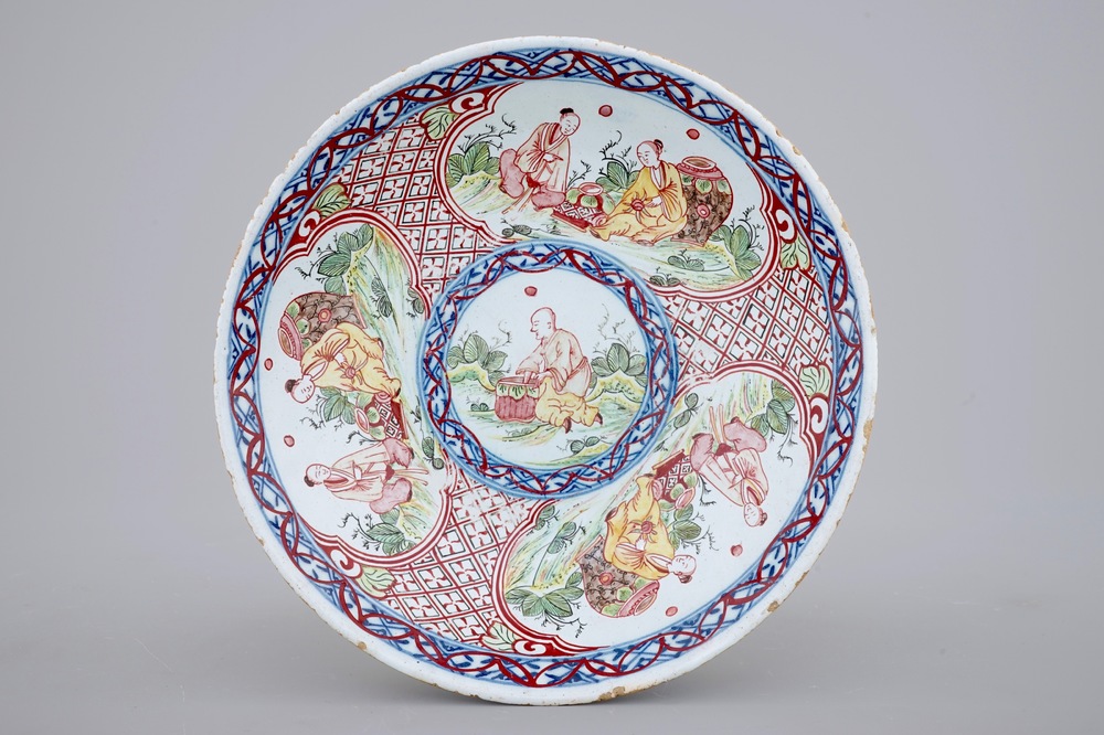 A blue and white Dutch Delft overdecorated plate with chinoiserie, 18th C.