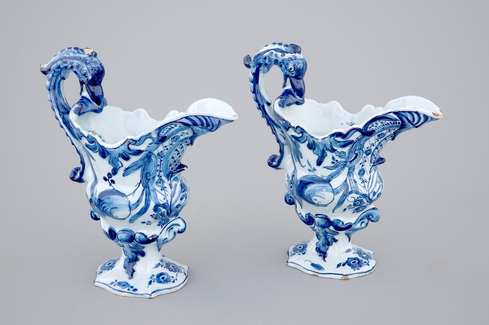 A pair of blue and white Dutch Delft helmet-shaped jugs, 18th C.