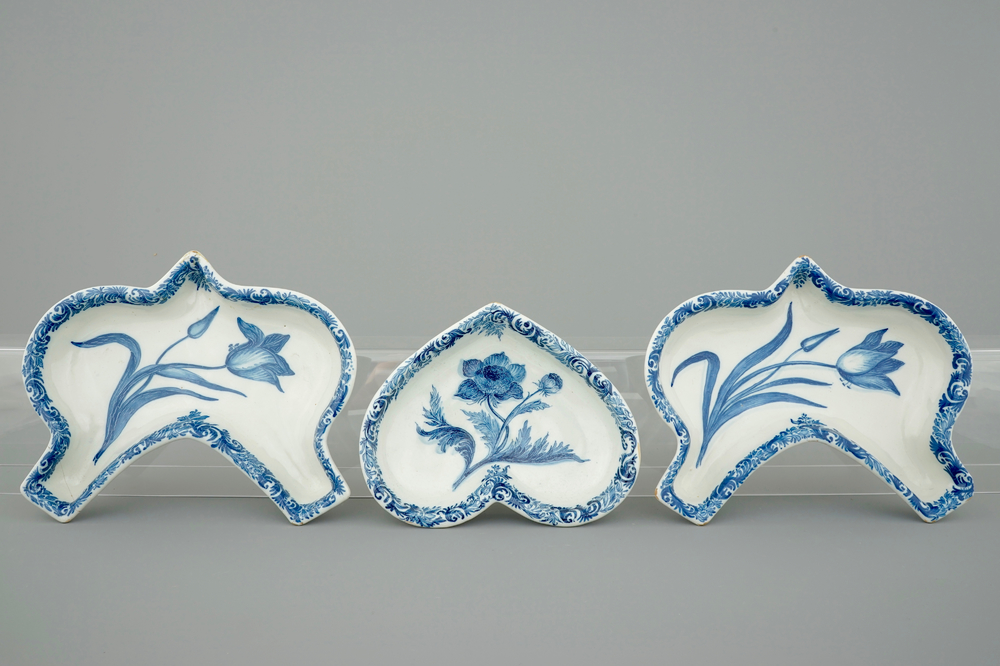Three Dutch Delft blue and white rice table dishes with flowers, 18th C.
