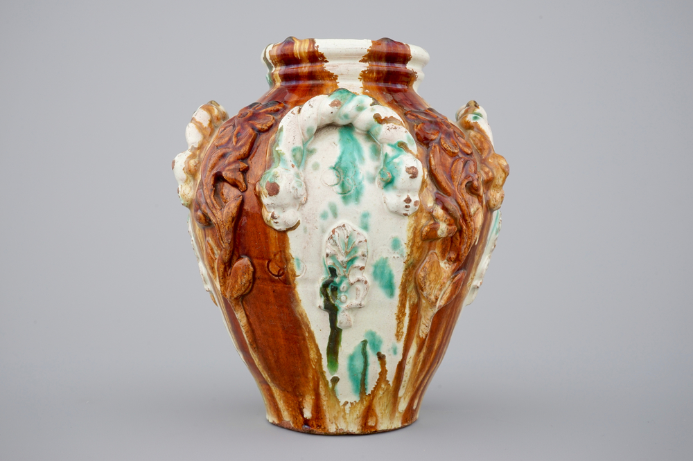A brown and green glazed relief decorated vase, Saintonge, France, 18th C.