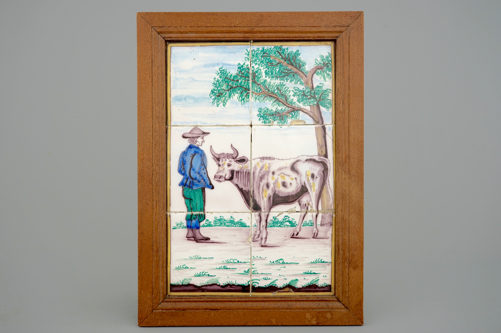 A polychrome Dutch Delft tile panel with a shepherd with cow, 19th C.