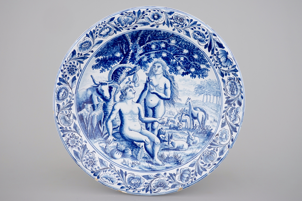 A large Dutch Delft blue and white dish with Adam and Eve, Makkum, Friesland, 19th C.