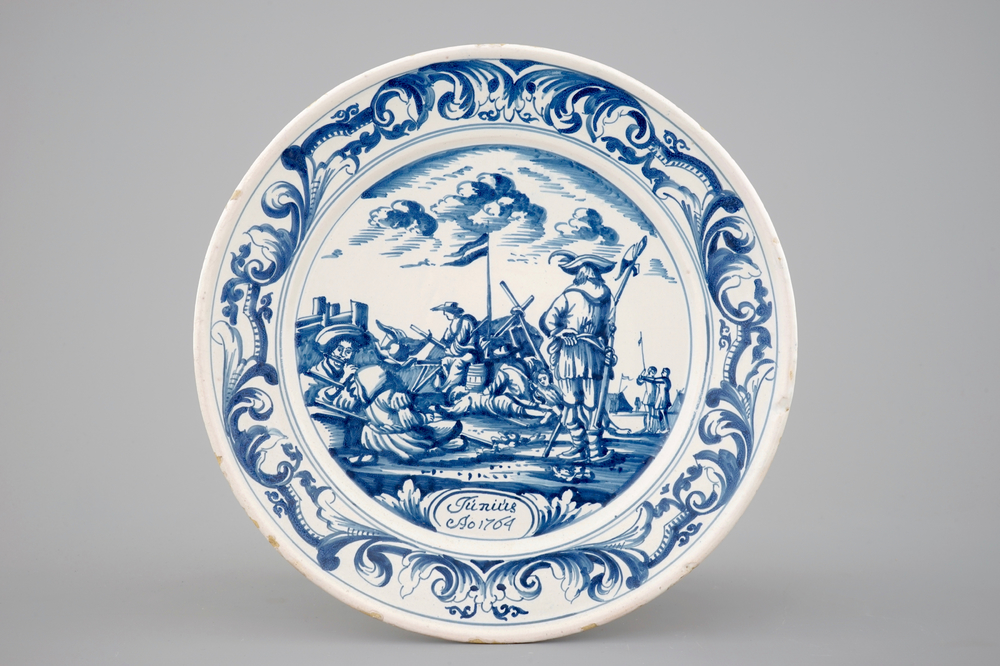 A blue and white plate with soldiers at camp, Makkum, Friesland, dated 1764