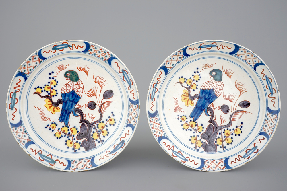 A pair of polychrome Dutch Delftware plates with parrots, 18th C.