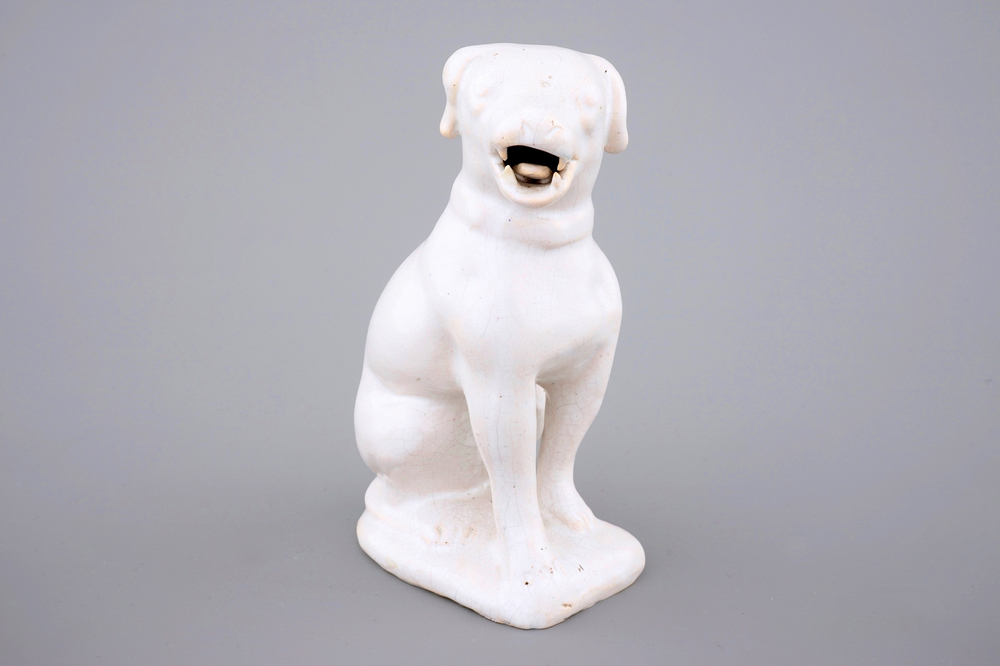 A white monochrome Dutch Delft figure of a dog, 18th C.