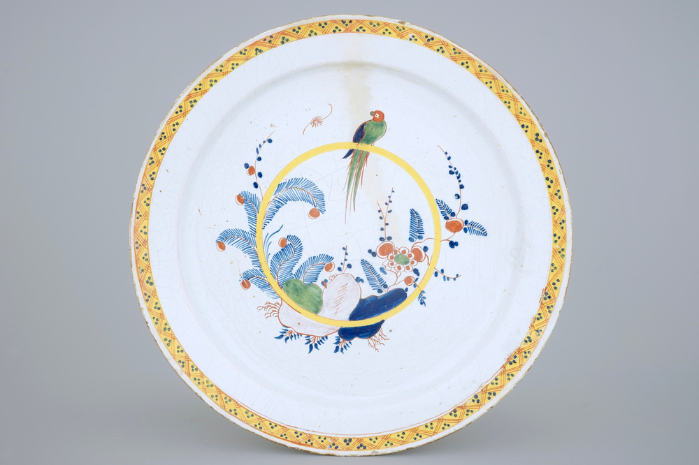 A very large polychrome Dutch Delft dish with a parrot, 18th C.