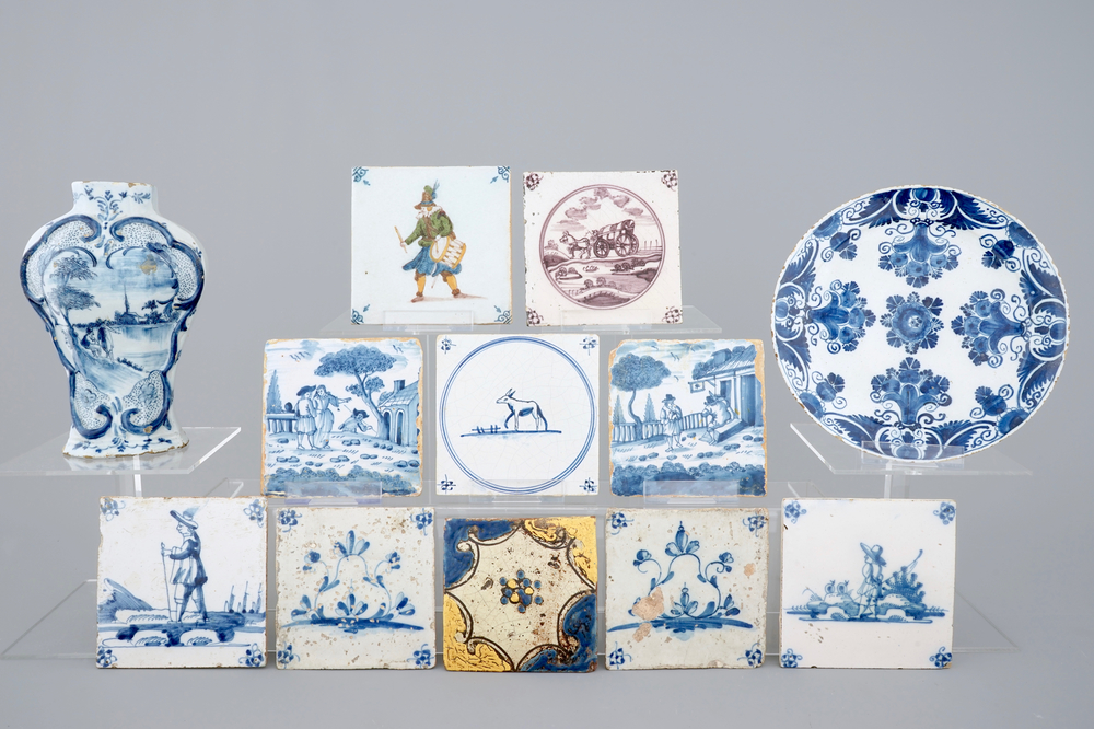 A Dutch Delft blue and white plate, a vase and a collection of tiles, 17/19th C.