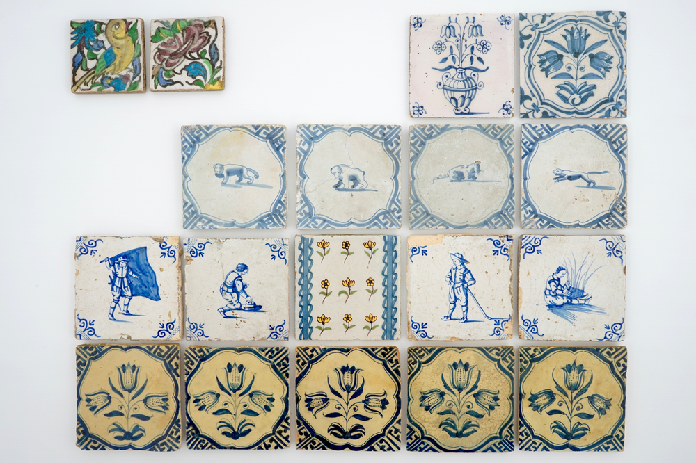 A set of 14 antique blue, white and polychrome Delft tiles, 17/19th C.
