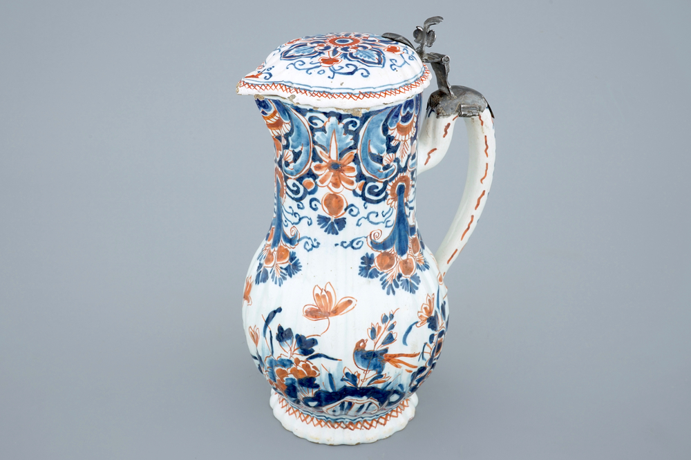 A polychrome Dutch Delft jug with cover, 18th C.