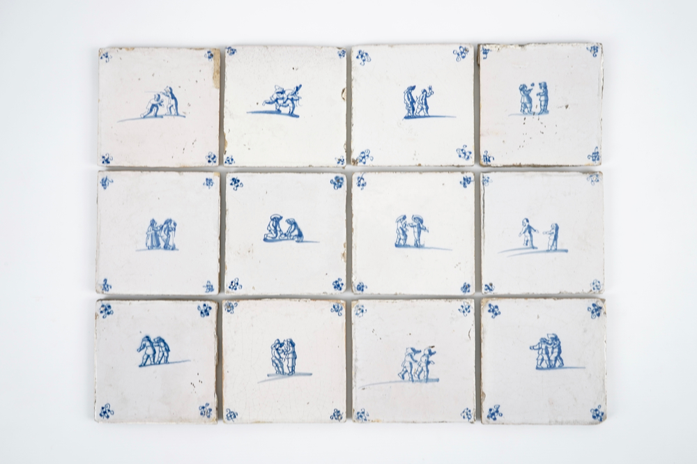 A set of 12 antique Dutch Delft tiles with children's games, 18th C.