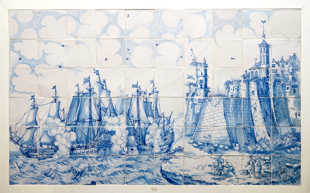 A large Dutch Delft tile panel with a sea coast battle, 17th C.