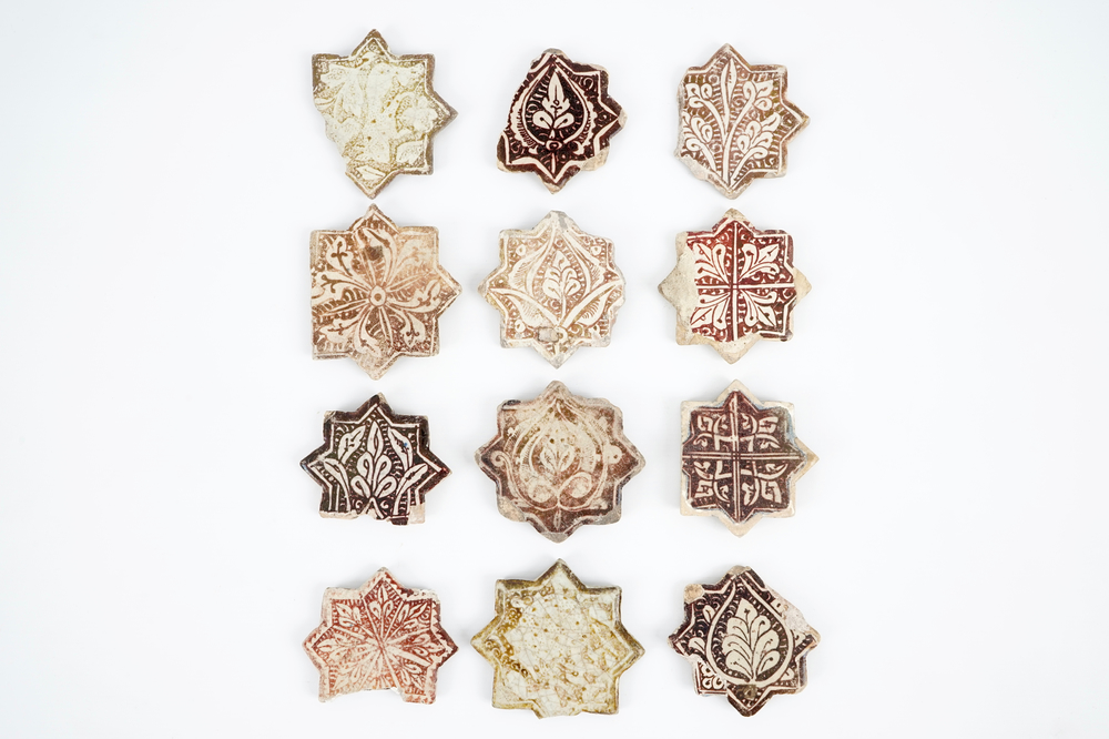 Twelve small Kashan star-shaped tiles, Central Persia, 13/14th C.