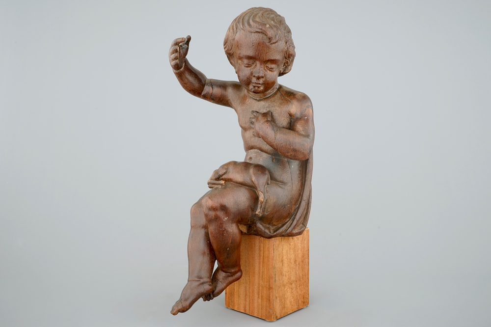 A wooden seated figure of the Jesus child with a lamb, 17/18th C.