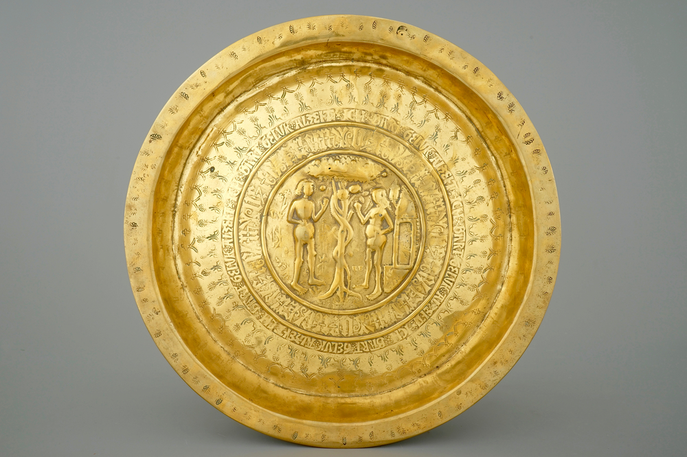 A large marked Nuremberg brass alms basin depicting Adam and Eve, 15th C.